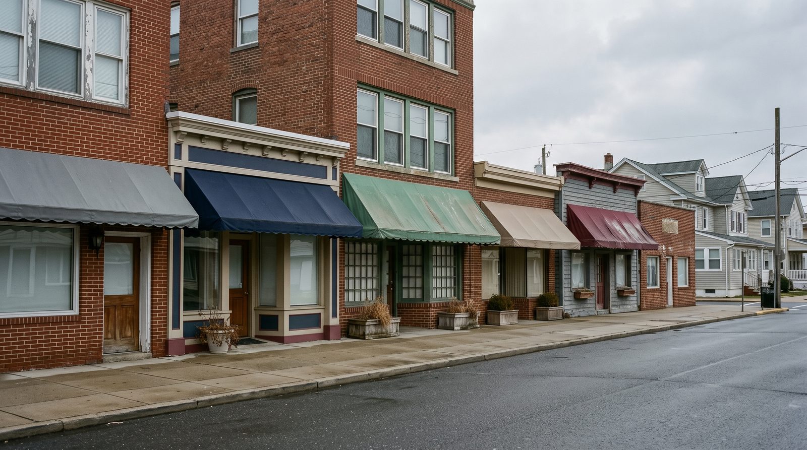 Row of small independent storefronts on a Jersey Shore main street.